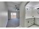 Spacious bedroom with plush carpet, ceiling fan, and sliding glass doors to a private balcony at 9436 Mount Cash Ave # 101, Las Vegas, NV 89129