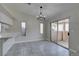 Dining area with tile flooring, modern chandelier, and access to an outdoor patio at 9436 Mount Cash Ave # 101, Las Vegas, NV 89129