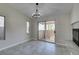 Dining room with chandelier and sliding glass doors to the patio; fireplace view at 9436 Mount Cash Ave # 101, Las Vegas, NV 89129