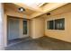 Welcoming home entrance with a storm door, window, and two overhead lights at 9436 Mount Cash Ave # 101, Las Vegas, NV 89129