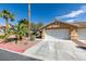 Inviting single-story home featuring a two-car garage and desert landscaping at 9436 Mount Cash Ave # 101, Las Vegas, NV 89129