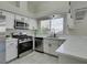 Beautiful kitchen offers stainless steel appliances, white cabinetry, and marble countertops at 9436 Mount Cash Ave # 101, Las Vegas, NV 89129