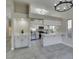 Open kitchen with white cabinets, stainless steel appliances, and modern lighting fixtures at 9436 Mount Cash Ave # 101, Las Vegas, NV 89129