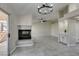 Open-concept living area with fireplace, tile floors, adjacent to kitchen and patio access at 9436 Mount Cash Ave # 101, Las Vegas, NV 89129
