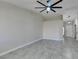 Open living room with neutral walls, tile flooring, and a contemporary ceiling fan at 9436 Mount Cash Ave # 101, Las Vegas, NV 89129