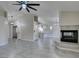 An open-plan living space featuring tile floors, fireplace, and kitchen in the background at 9436 Mount Cash Ave # 101, Las Vegas, NV 89129