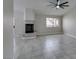 Bright living room featuring tile flooring, a large ceiling fan, and a tiled fireplace at 9436 Mount Cash Ave # 101, Las Vegas, NV 89129