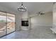 Open living space with fireplace, tile flooring, and access to the patio at 9436 Mount Cash Ave # 101, Las Vegas, NV 89129