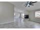 Spacious living room featuring tile flooring, fireplace, and a modern ceiling fan at 9436 Mount Cash Ave # 101, Las Vegas, NV 89129