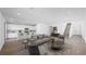 Bright and open-concept living room with modern finishes and wood flooring throughout the main level at 100 Via Franello, Henderson, NV 89011