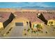 Overhead shot showcases the home's tile roof, three car garage, desert landscaping, and community setting at 1130 Calico Rdg, Mesquite, NV 89034
