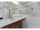 Modern bathroom with a large frameless shower, vanity with granite countertop, and tiled walls at 1130 Calico Rdg, Mesquite, NV 89034