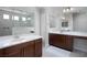 Modern bathroom featuring dual vanities, a large mirror, and a spacious walk-in shower at 1130 Calico Rdg, Mesquite, NV 89034