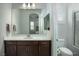 Modern bathroom with dark wood cabinets, large mirror, and white countertop at 1130 Calico Rdg, Mesquite, NV 89034