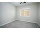 Neutral-toned bedroom featuring a ceiling fan, window, and gray carpeting at 1130 Calico Rdg, Mesquite, NV 89034