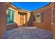 Charming front courtyard with tiled patio and home's architectural details at 1130 Calico Rdg, Mesquite, NV 89034