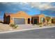 Charming single-story home featuring a spacious three car garage, stucco exterior, and desert landscaping at 1130 Calico Rdg, Mesquite, NV 89034