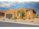 Charming single-story home with a spacious three car garage, desert landscaping and shuttered windows at 1130 Calico Rdg, Mesquite, NV 89034