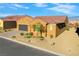 Charming single-story home featuring a spacious two car garage, stucco exterior, and desert landscaping at 1130 Calico Rdg, Mesquite, NV 89034