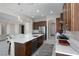 Modern kitchen with island seating, marble countertops, and stainless steel appliances at 1130 Calico Rdg, Mesquite, NV 89034