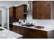 Modern kitchen featuring dark wood cabinetry, stainless steel appliances, and a quartz countertop with unique veining at 1130 Calico Rdg, Mesquite, NV 89034