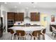 Stylish kitchen featuring a large island with seating, modern appliances, and elegant lighting at 1130 Calico Rdg, Mesquite, NV 89034