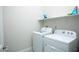 Efficient laundry room with white washer, dryer, and shelf space at 1130 Calico Rdg, Mesquite, NV 89034