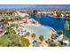 Beautiful aerial view of a community lagoon, clubhouse, and beach area with mountain views at 3125 N Buffalo Dr # 2103, Las Vegas, NV 89128
