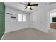Bedroom with carpet, ceiling fan, window with shutters, and view into ensuite bath at 375 Elks Peak Ave, North Las Vegas, NV 89084