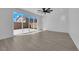 Bedroom with wood floors, modern ceiling fan, large windows, and sliding doors to backyard at 375 Elks Peak Ave, North Las Vegas, NV 89084