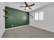 Bedroom with accent wall, ceiling fan, and window with plantation shutters at 375 Elks Peak Ave, North Las Vegas, NV 89084