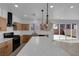 Open kitchen boasts stainless appliances, quartz countertops, island and sliding door to the backyard at 375 Elks Peak Ave, North Las Vegas, NV 89084