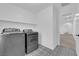 Laundry room boasts a patterned floor and modern washer and dryer at 375 Elks Peak Ave, North Las Vegas, NV 89084