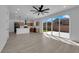 Open-concept living space features a kitchen with island and modern wood-look flooring at 375 Elks Peak Ave, North Las Vegas, NV 89084