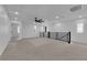 Spacious loft area with plush carpeting, modern railing, and plenty of natural light at 375 Elks Peak Ave, North Las Vegas, NV 89084
