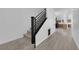This staircase features modern design with wood floors and leads to an open-concept living space at 375 Elks Peak Ave, North Las Vegas, NV 89084