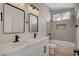 This bathroom has a double sink vanity, a window and a tiled shower-bathtub combo at 4010 Herblinda Ln, North Las Vegas, NV 89032