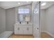 Bathroom with a double sink vanity, stylish mirrors, and a walk-in shower at 4010 Herblinda Ln, North Las Vegas, NV 89032