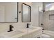This bathroom has a double sink vanity, a window and a tiled shower-bathtub combo at 4010 Herblinda Ln, North Las Vegas, NV 89032