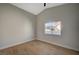 Bedroom with vaulted ceiling, wood floors, and bright window at 4010 Herblinda Ln, North Las Vegas, NV 89032