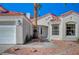 Close-up of the home's facade featuring desert landscaping, a red tile roof, and the main entrance at 4010 Herblinda Ln, North Las Vegas, NV 89032