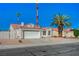 Attractive single-story home with a red tile roof, a two-car garage, and desert landscaping with mature palm trees at 4010 Herblinda Ln, North Las Vegas, NV 89032