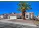 Beautiful single-story house with red tile roof, desert landscaping, and a two-car garage in a sunny neighborhood at 4010 Herblinda Ln, North Las Vegas, NV 89032