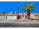 Charming single-story home with a red tile roof, a two-car garage, and desert landscaping with a large palm tree at 4010 Herblinda Ln, North Las Vegas, NV 89032