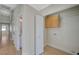 A look down the hallway to the laundry area that includes a cabinet and storage at 4010 Herblinda Ln, North Las Vegas, NV 89032
