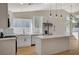 Bright, modern kitchen featuring white cabinets, stainless steel appliances, and a central island with marble countertops at 4010 Herblinda Ln, North Las Vegas, NV 89032