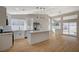 Modern kitchen with stainless appliances, white cabinetry, and an island, adjacent to the dining area at 4010 Herblinda Ln, North Las Vegas, NV 89032