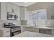 Updated kitchen with stainless appliances, marble counters, and a gas range at 4010 Herblinda Ln, North Las Vegas, NV 89032