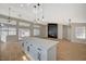 Open-concept kitchen with island and great room with accent wall and fireplace at 4010 Herblinda Ln, North Las Vegas, NV 89032