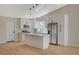 Modern kitchen features stainless appliances, white cabinetry, an island, and stylish pendant lighting at 4010 Herblinda Ln, North Las Vegas, NV 89032